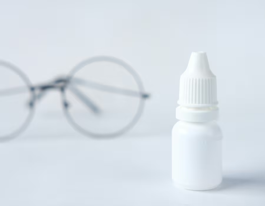 Glasses and eyedrop bottle
